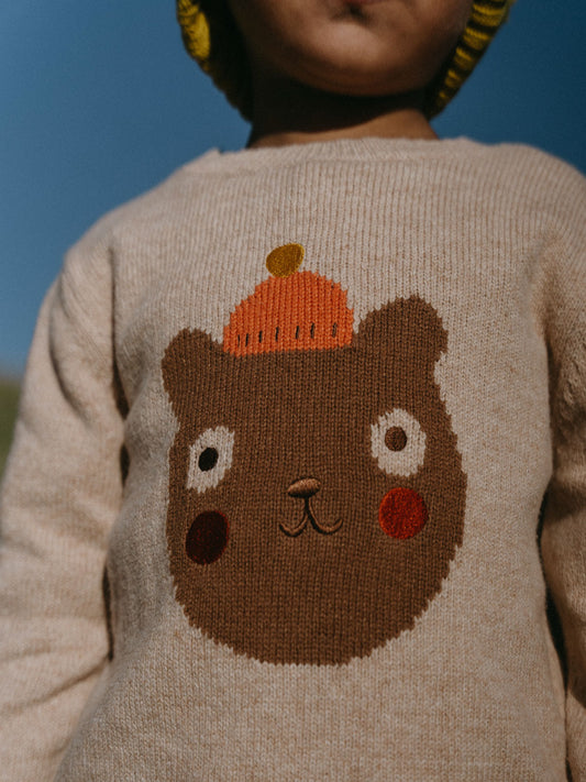 Child wearing beige knit sweater with brown bear and pumpkin design on back Feature Print Jumper - Happy Bear Boys