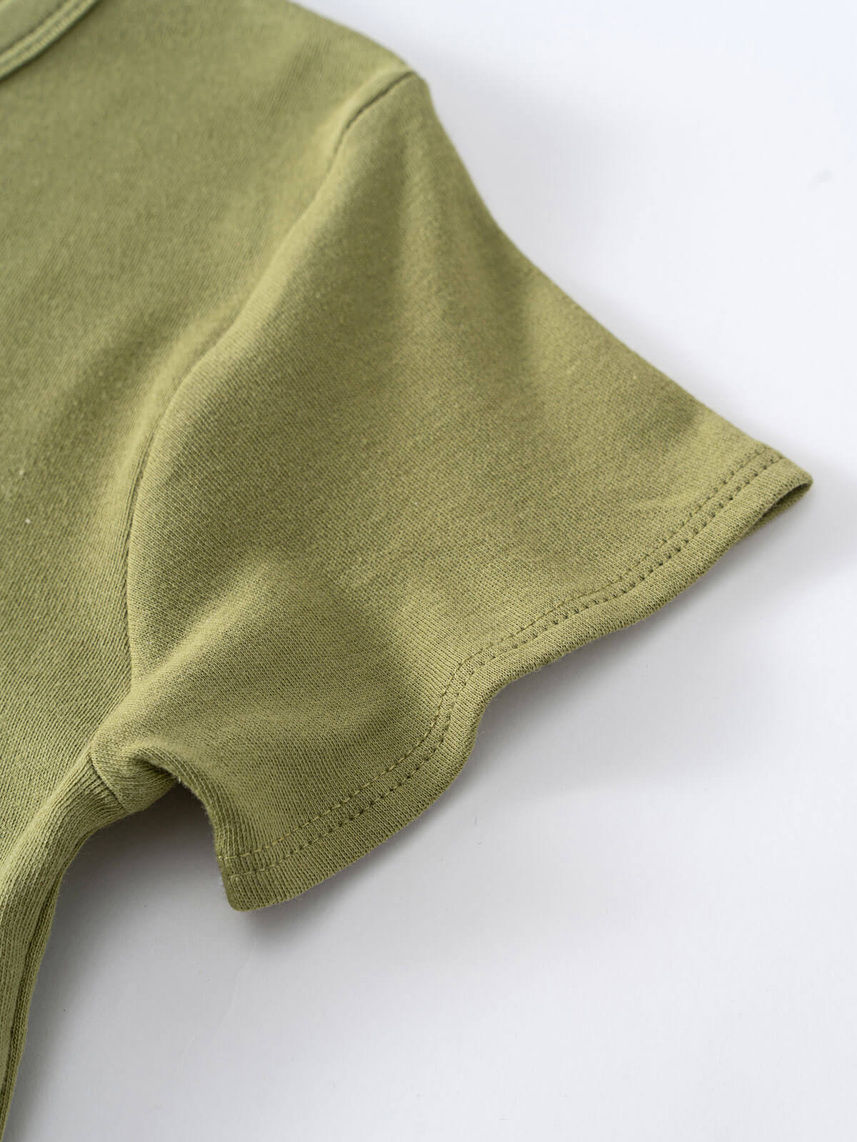 Close-up of olive green shirt sleeve with visible stitching detail Henley Short Sleeve Tee - Moss Boys