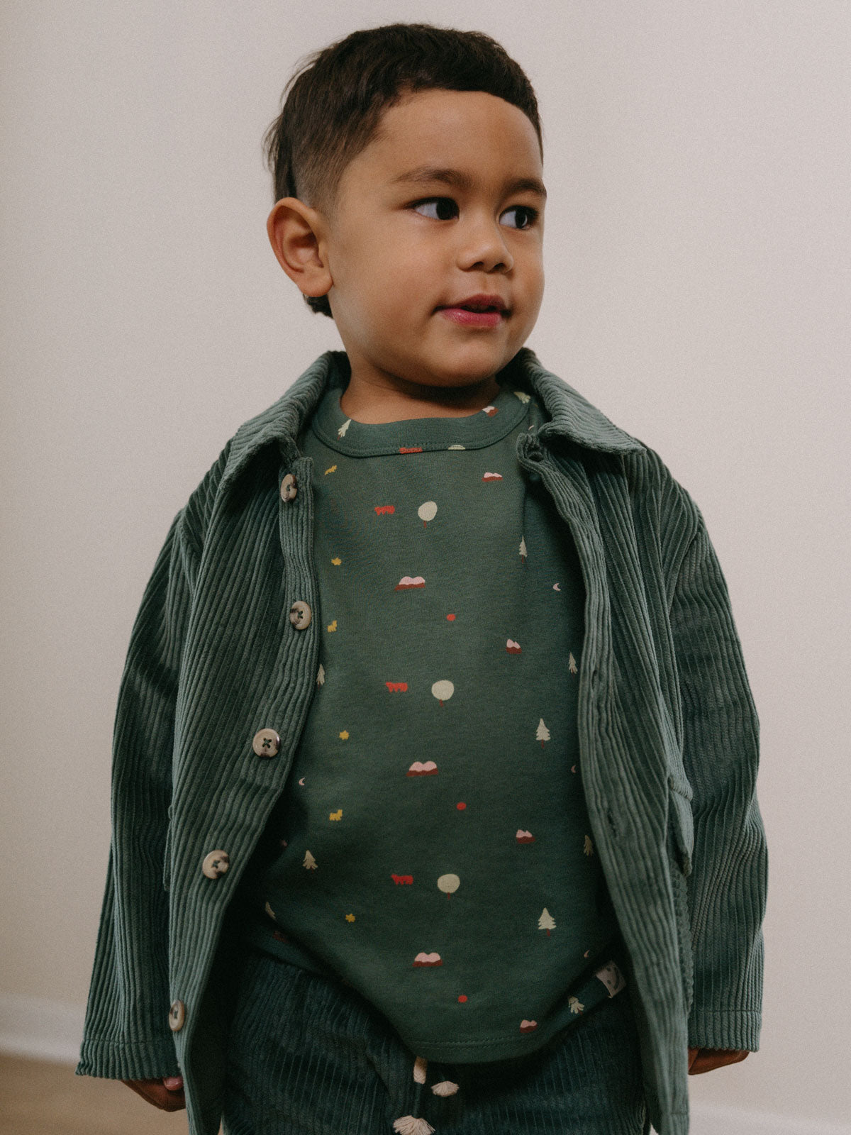 Young boy wearing a green patterned shirt and corduroy jacket against white background Printed Long Sleeve Tee - Mountain View Balsam Boys