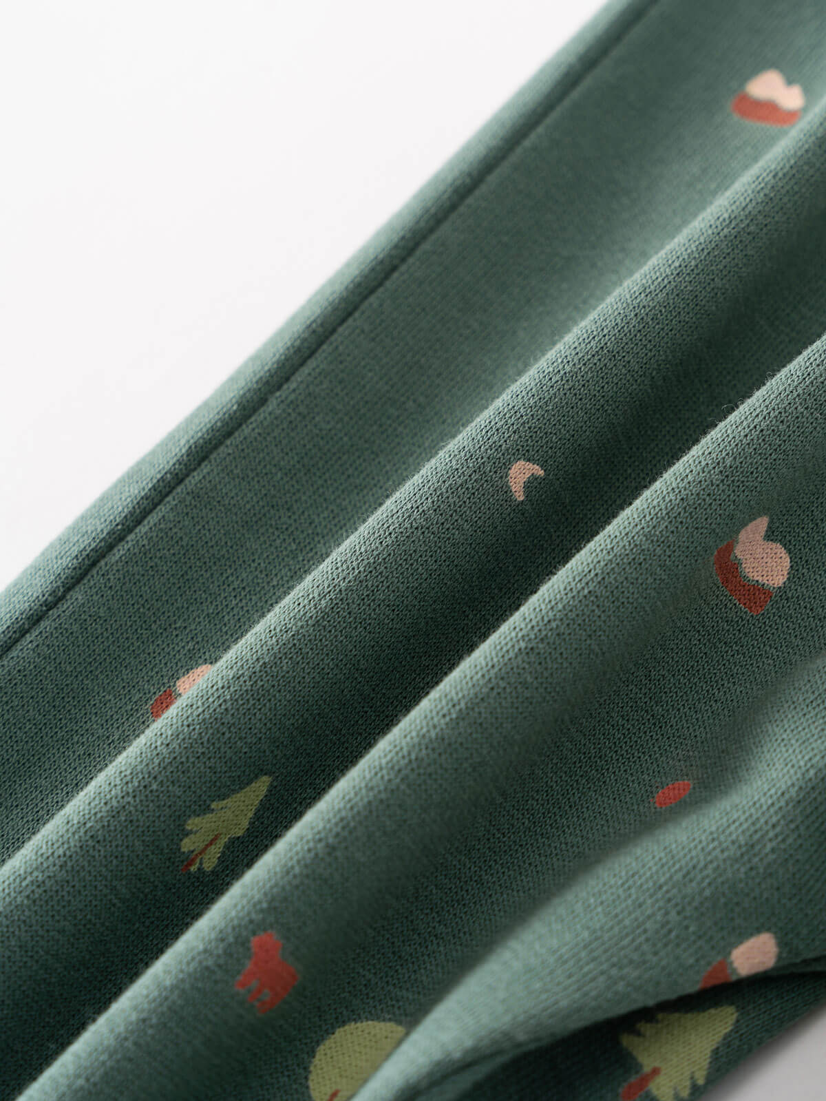 Close-up of sage green fabric with small colorful printed details Printed Sweatpants - Mountain View Balsam Baby boy