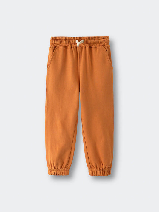 Orange sweatpants with elastic waistband and cuffs on white background Sweatpants - Pumpkin Boys