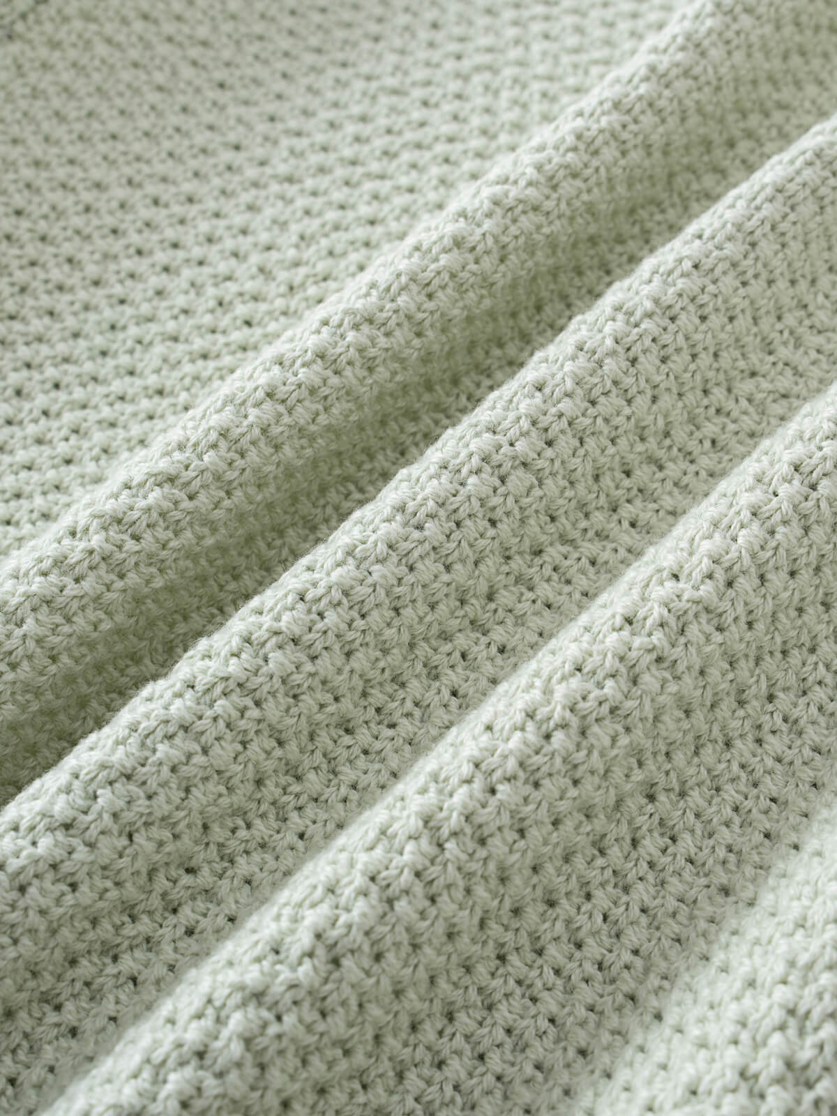 Close-up of mint green knitted fabric with textured stitching and folds Anna Cardigan - Mint Girls