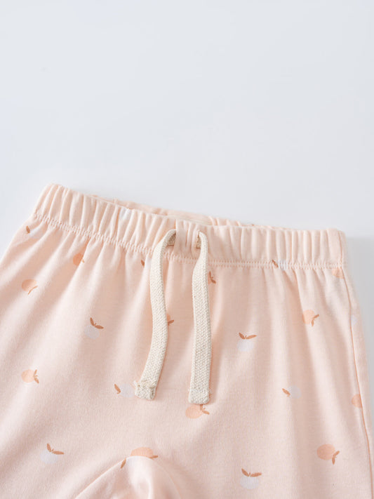 Close-up of pale pink shorts with apple print and cream drawstring Baby Jersey Shorts - Apples Baby girl