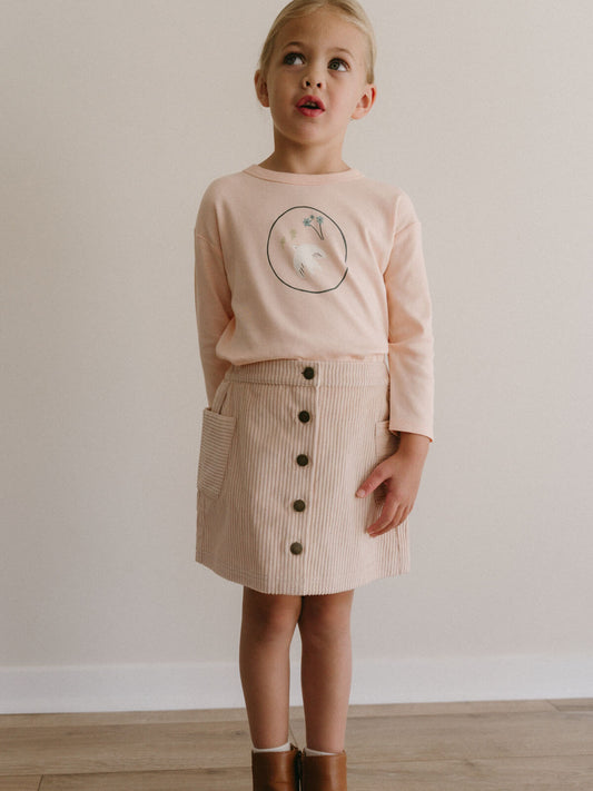 Young girl wearing a pink sweater with a graphic and a beige buttoned skirt against a plain background Corduroy Skirt - Clay Girls