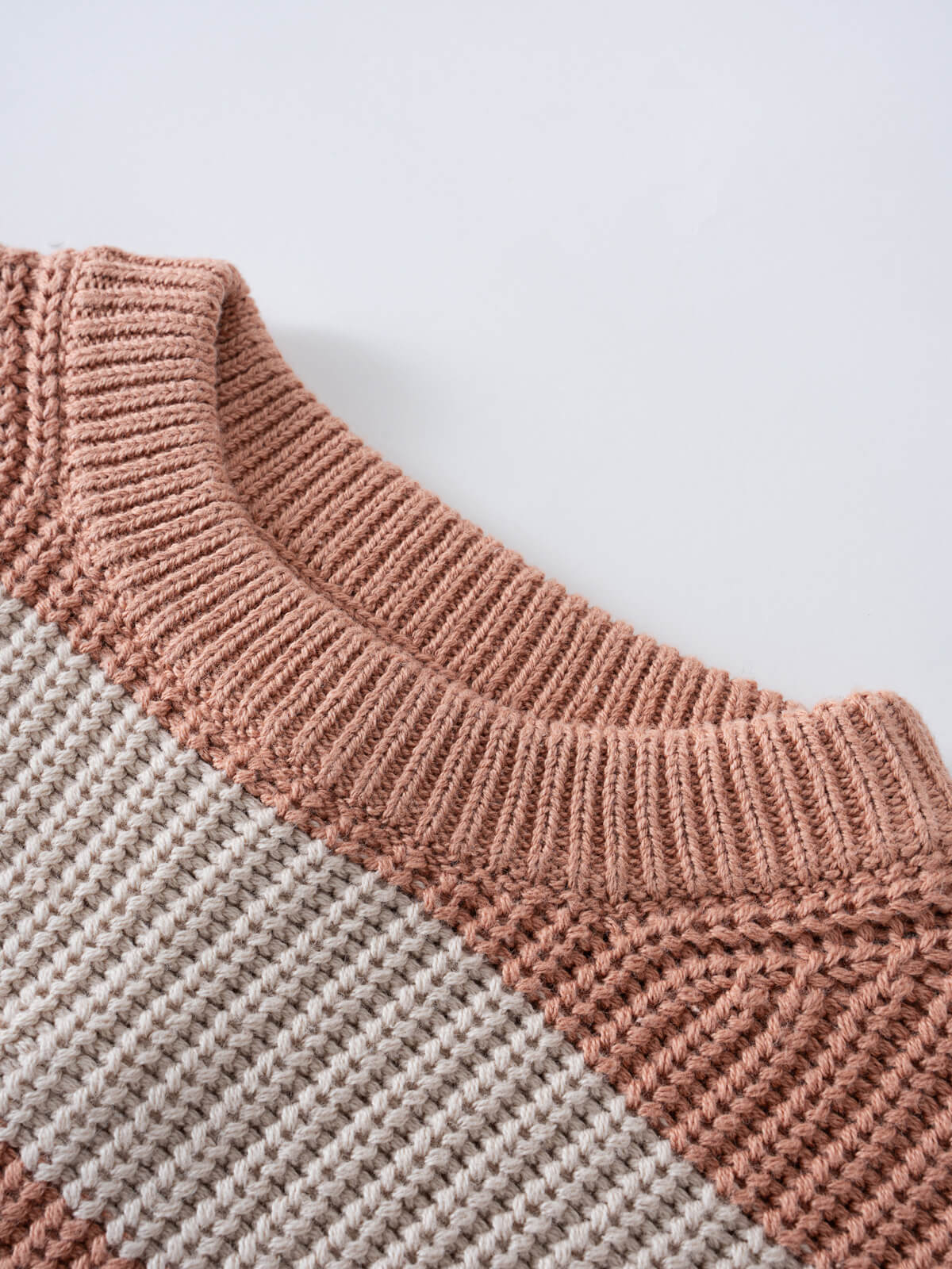 Close-up of a knitted sweater collar with ribbing in peach and cream stripes Isabel Jumper - Toasted Peach Stripe Girls