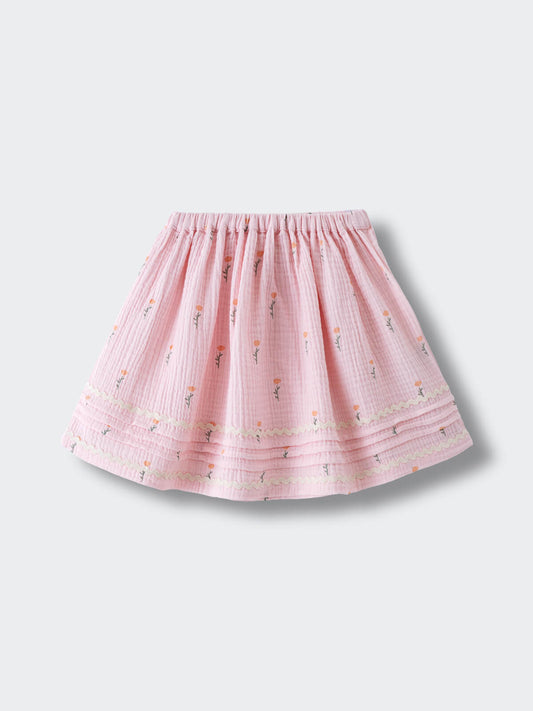 Pink embroidered skirt with floral pattern and elastic waistband laid flat Muslin Skirt - Poppy Field Girls
