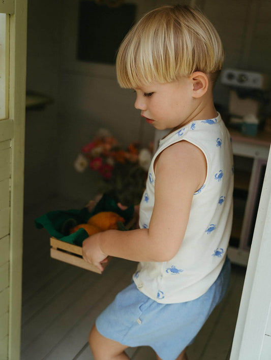 Child holding a wooden crate with vegetables in a kitchen setting Rowan Sleeveless Tee - Mr Crab Boys