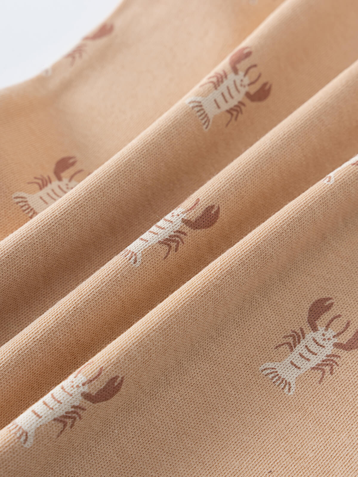 Close-up of peach fabric with brown lobster print pattern Theo Sleeveless Bodysuit - Charlie's Crew Baby boy