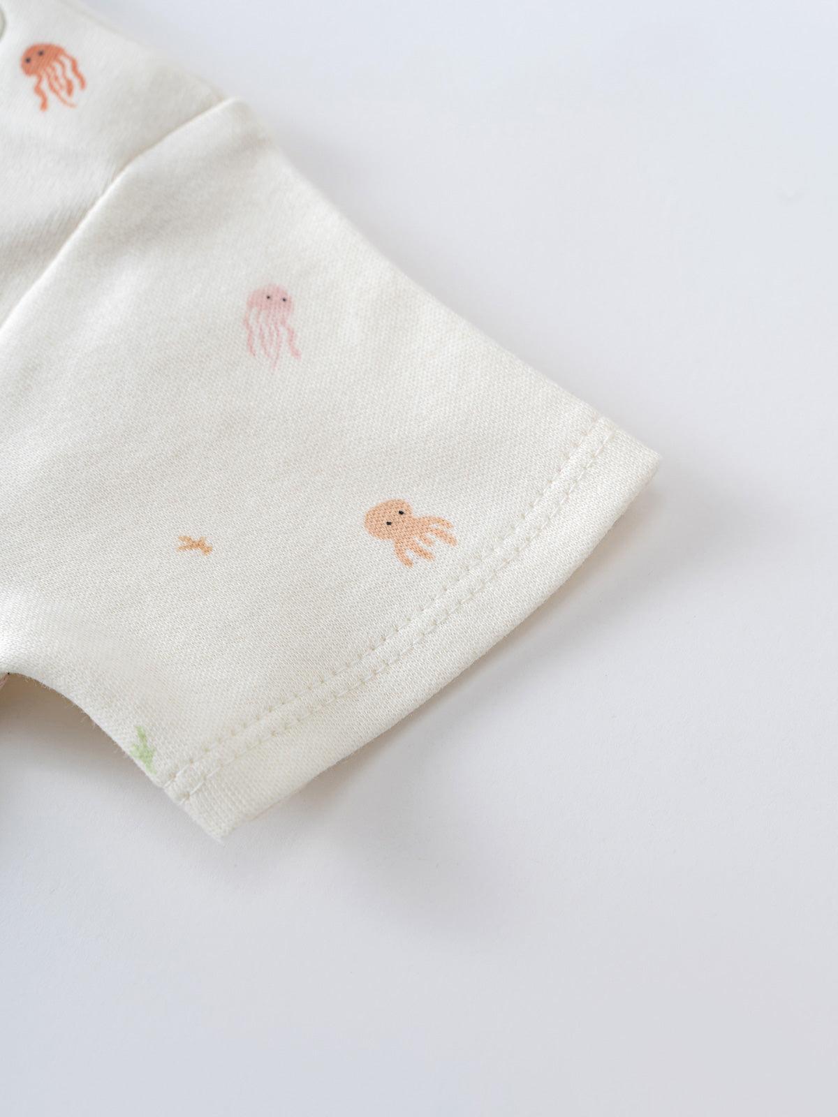 White fabric with small embroidered jellyfish and sea creatures pattern Zoe Short Sleeve Bodysuit - Ocean Buddies Baby girl