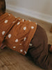 Child wearing orange bear-patterned long sleeve shirt over brown pants while sitting Baby Printed Long Sleeve Tee - Cosy Bear Russet Baby boy