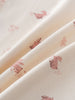 Close-up of cream fabric with pink animal prints including rabbits and dinosaurs Baby Printed Short Sleeve Tee - Meadow Friends Ecru Baby girl