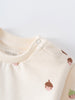 Close-up of cream sweatshirt with acorn print and snap button detail Baby Printed Sweatshirt - Little Acorn Ecru Baby girl
