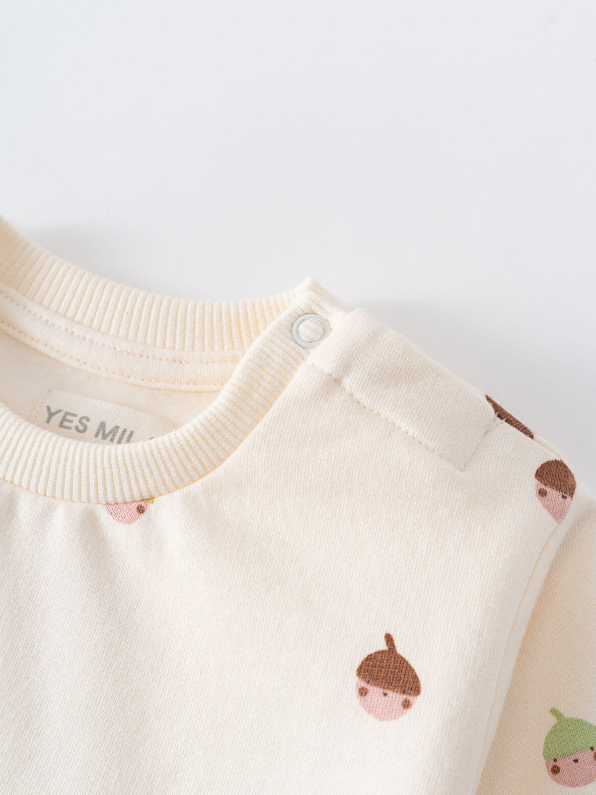 Close-up of cream sweatshirt with acorn print and snap button detail Baby Printed Sweatshirt - Little Acorn Ecru Baby girl