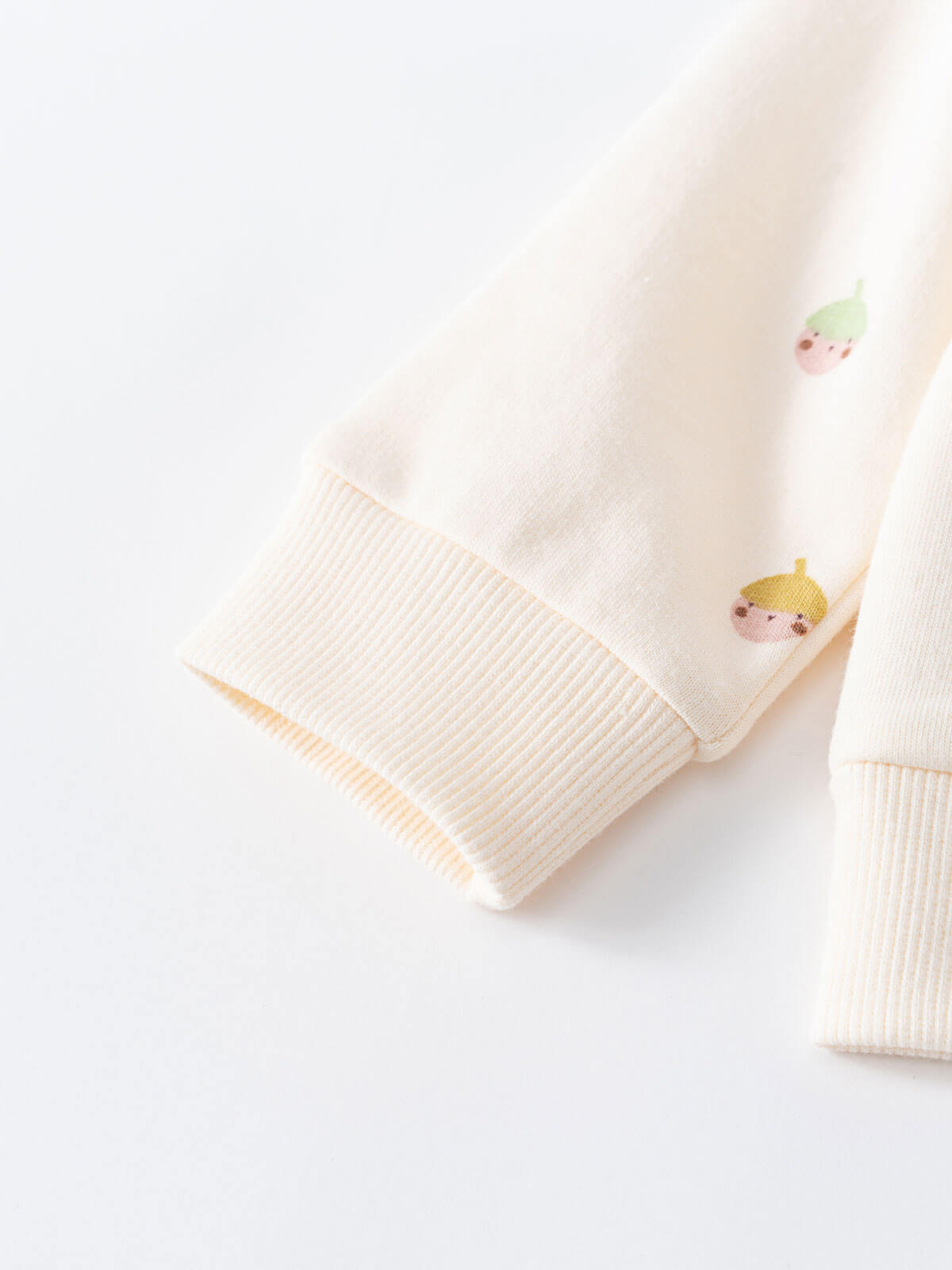 Close-up of cream colored ribbed knit cuff with small embroidered fruit details Baby Printed Sweatshirt - Little Acorn Ecru Baby girl