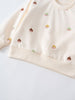 Close-up of cream sweatshirt with embroidered acorn faces pattern Baby Printed Sweatshirt - Little Acorn Ecru Baby girl