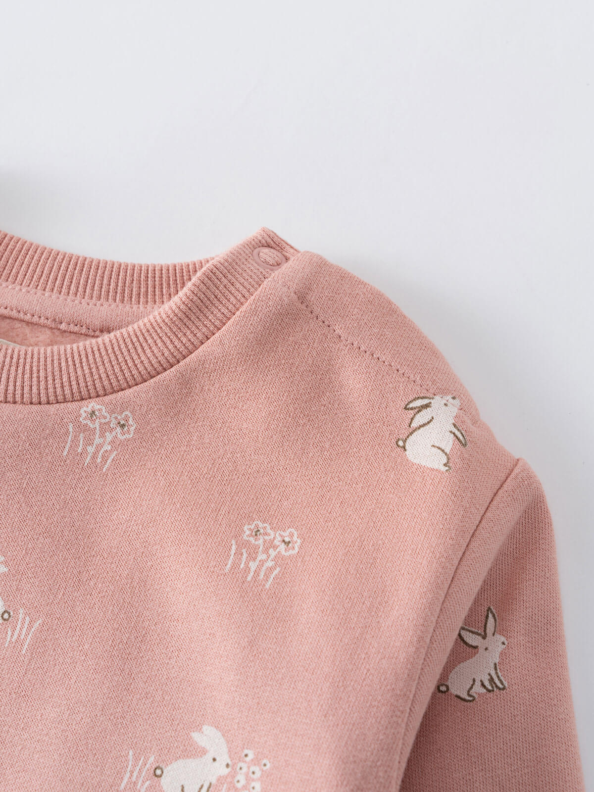 Close-up of a pink knit sweater with embroidered animal designs Baby Printed Sweatshirt - Meadow Friends Blush Baby girl