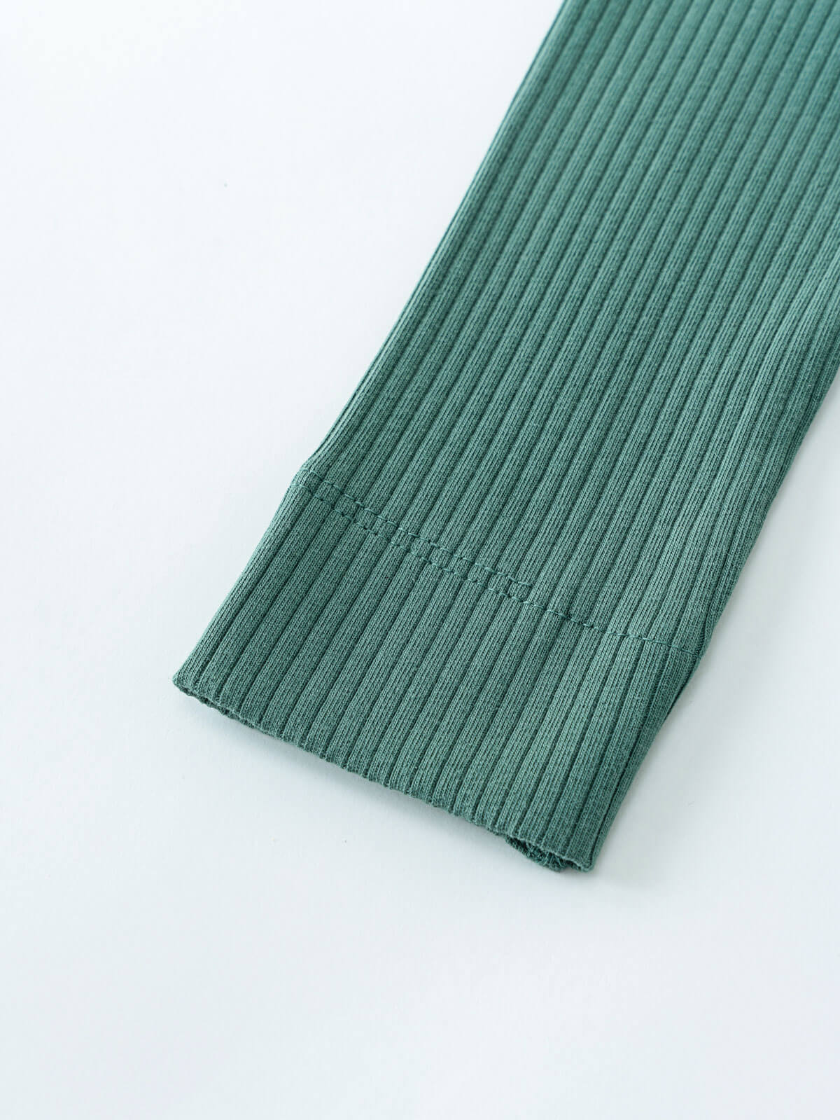 Close-up of ribbed teal fabric showing texture and raw edge detail Baby Ribbed Leggings - Balsam Baby girl