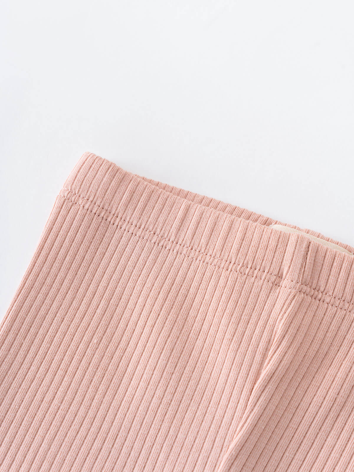 Close-up of pink ribbed fabric showing texture and stitching detail Baby Ribbed Leggings - Blush Baby girl