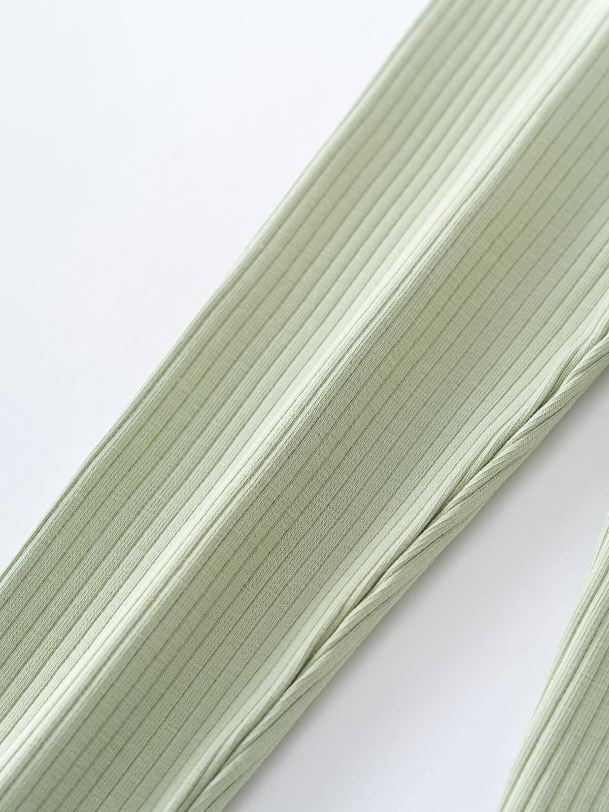 Close-up of pale green ribbed fabric strands on white background Baby Ribbed Leggings - Sage Baby boy