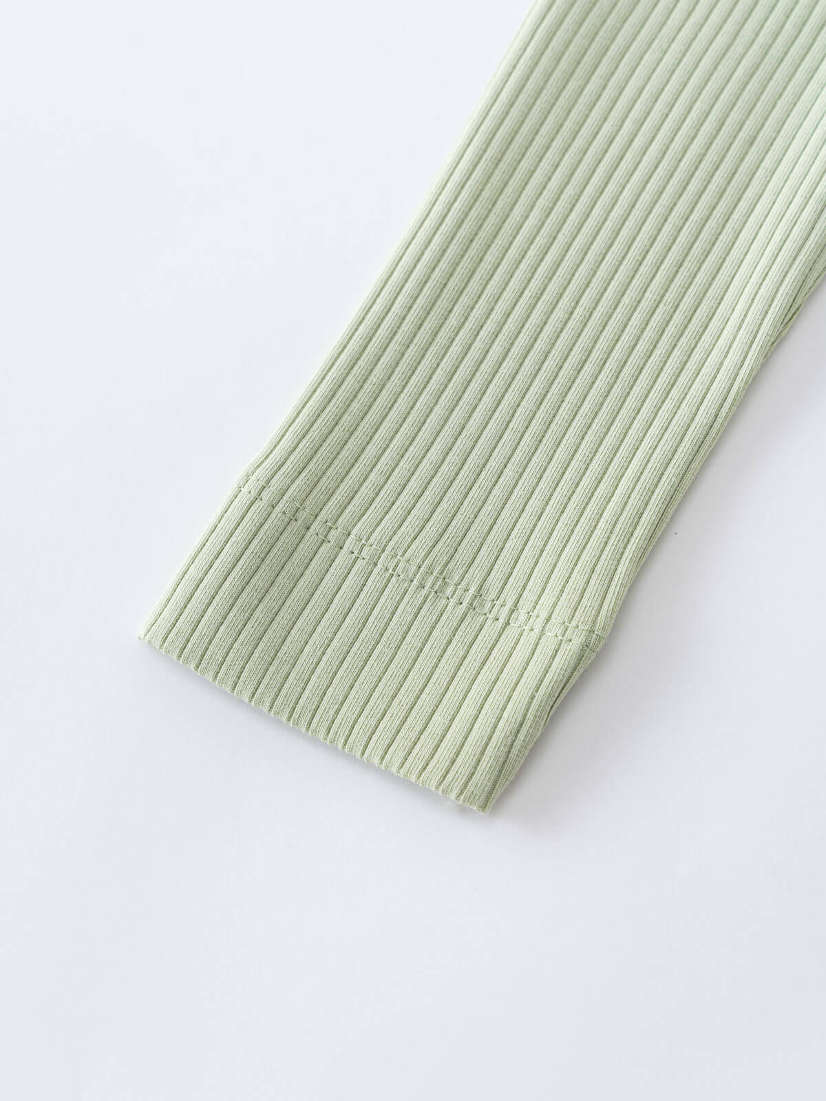 Close-up of ribbed sage green fabric with vertical textured lines Baby Ribbed Leggings - Sage Baby boy