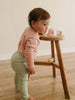Toddler wearing pink top and green ribbed leggings standing by wooden stool Baby Ribbed Leggings - Sage Baby boy