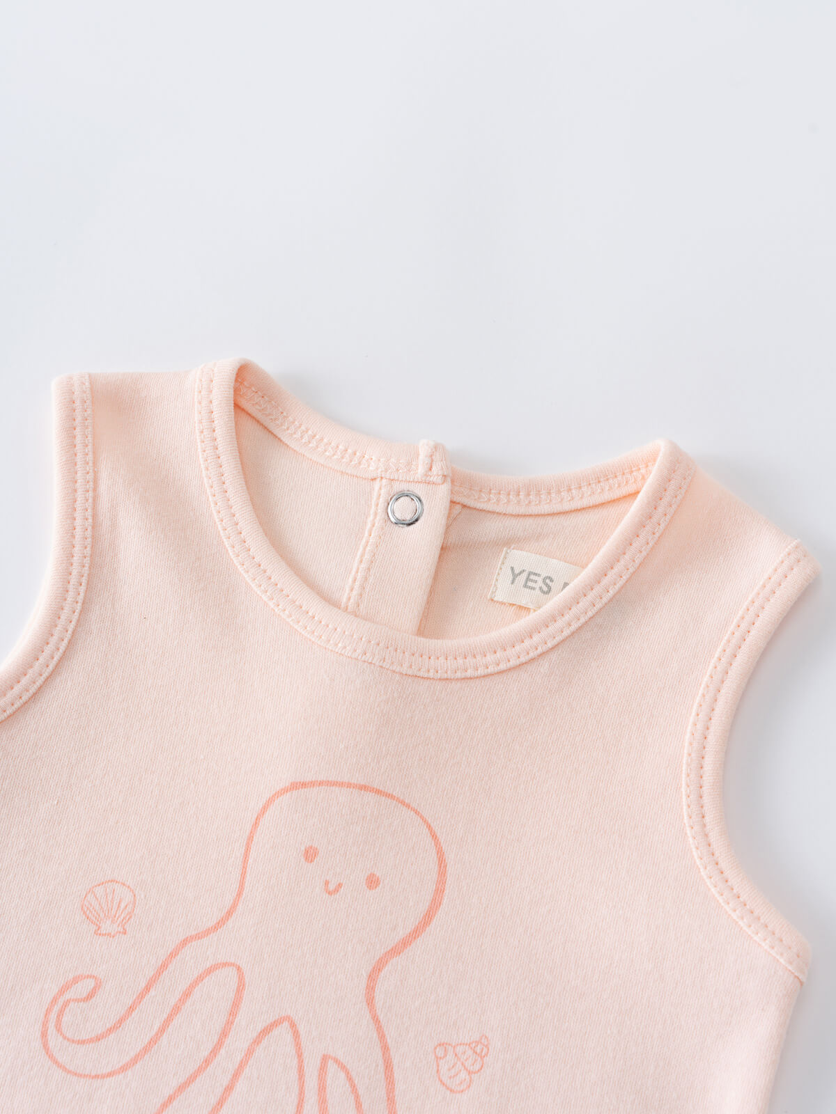 Close-up of a peach sleeveless baby tee with octopus print and snap closure Baby Sleeveless Tee - Octy Baby girl