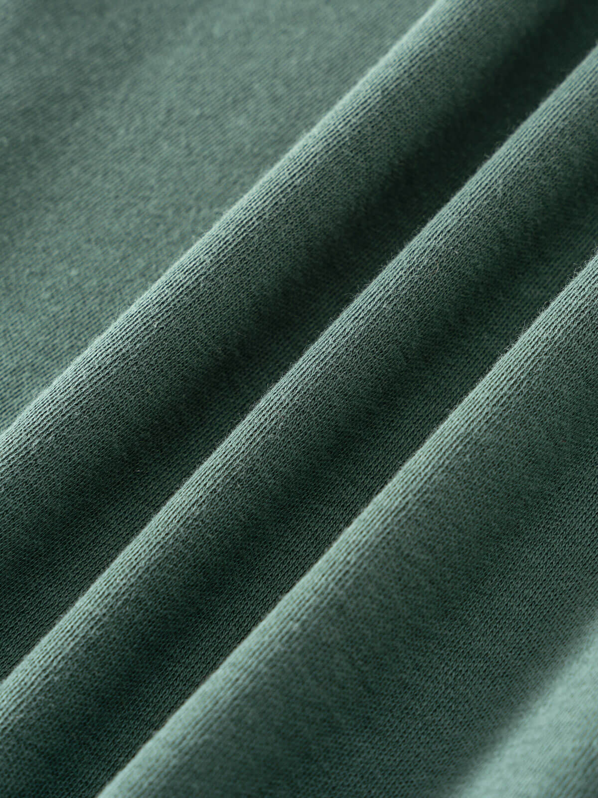 Close-up of sage green fabric showing texture and folds Baby Feature Print Long Sleeve Tee - Meadow Friends Baby girl