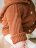 Baby wearing a rust-colored ribbed knit cardigan with hood and buttons Ribbed Hooded Cardigan - Russet Baby boy
