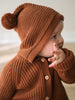 Baby wearing a rust-colored ribbed knit cardigan and matching hooded hat with pompom Ribbed Hooded Cardigan - Russet Baby boy