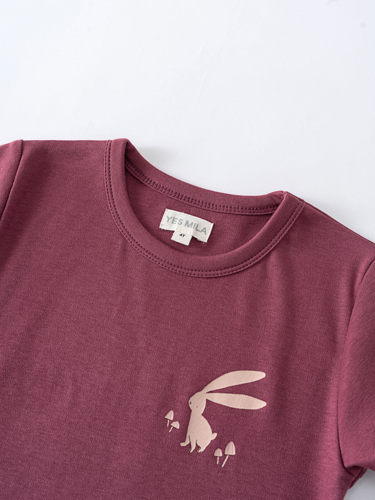 Close-up of a burgundy t-shirt with a rabbit and mushroom print Feature Print Short Sleeve Tee - Forest Gathering Girls