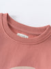 Close-up of a dusty rose sweatshirt neckline with white label Feature Print Sweatshirt - Forest Gathering Girls