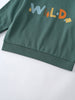 Close-up of green sweatshirt hem with colorful "WILD" text and nature graphics Feature Print Sweatshirt - Wild Baby boy