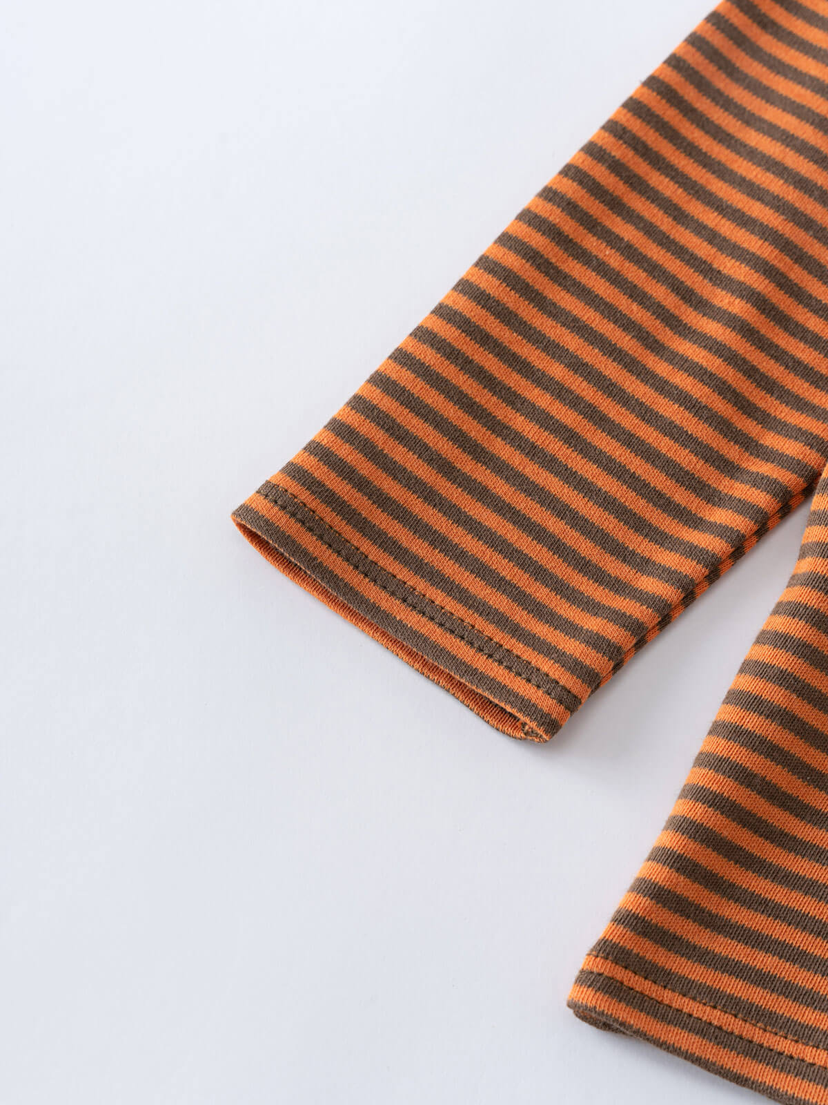 Close-up of orange and brown striped knit fabric sleeve cuffs Henley Long Sleeve Tee - Pumpkin Boys