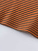 Close-up of orange and brown striped knit fabric with curved hem edge Henley Long Sleeve Tee - Pumpkin Boys