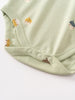 Close-up of a pale green baby bodysuit with snap buttons and small acorn prints Henley Short Sleeve Bodysuit - Little Acorn Sage Baby boy