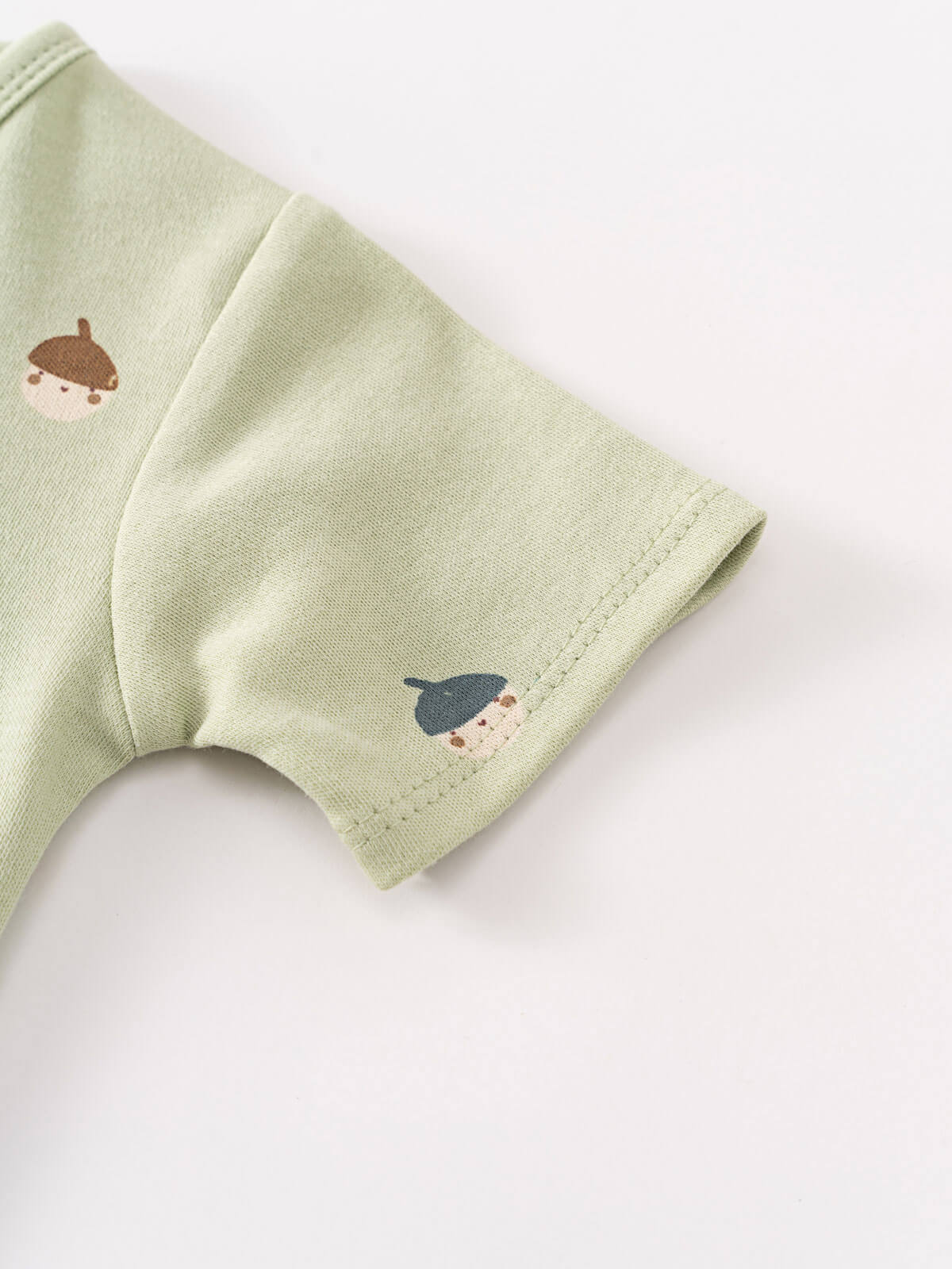 Close-up of sage green fabric sleeve with small acorn embroidery detail Henley Short Sleeve Bodysuit - Little Acorn Sage Baby boy