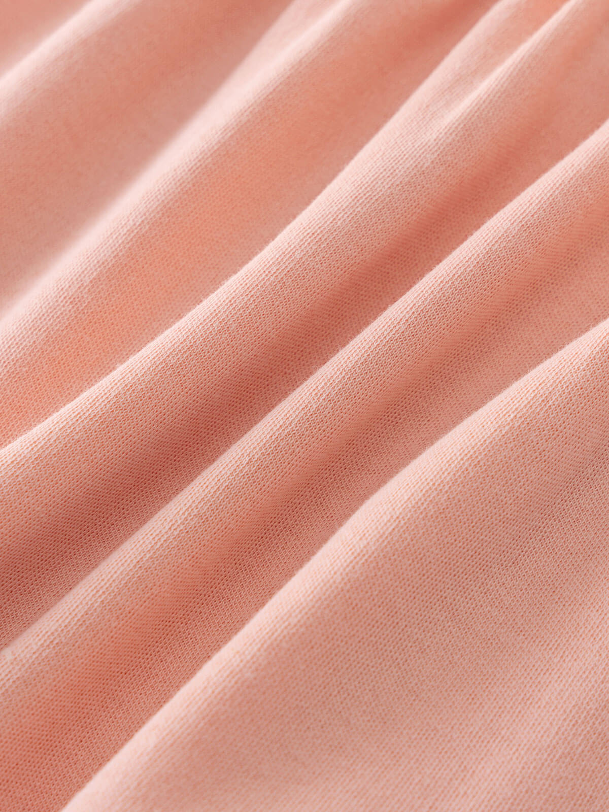 Close-up of soft peach-colored jersey fabric with diagonal folds and texture Jersey Skirt - Mallow Girls