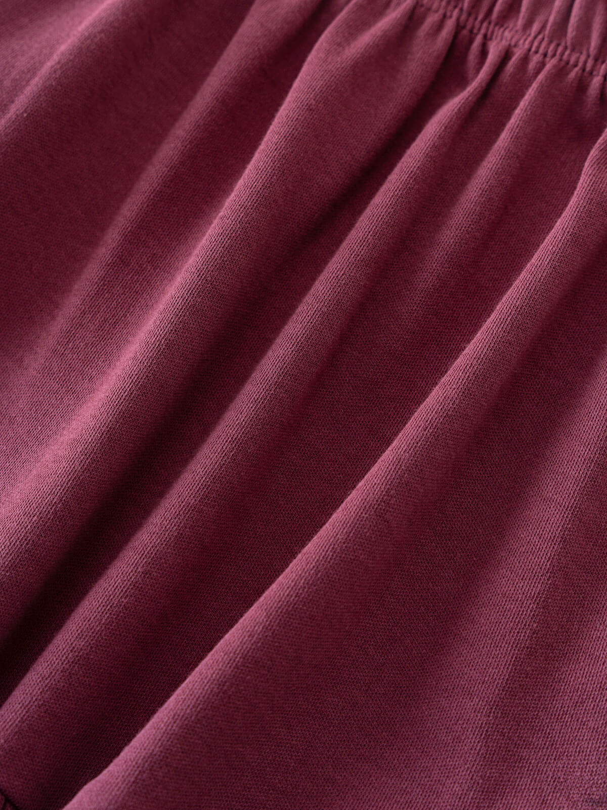 Close-up of draped plum-colored jersey fabric with elastic waistband visible Jersey Skirt - Plum Jam Girls