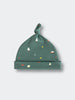 Green baby hat with knotted top featuring small trees and mountain motifs Knot Hat - Mountain View Balsam Baby boy