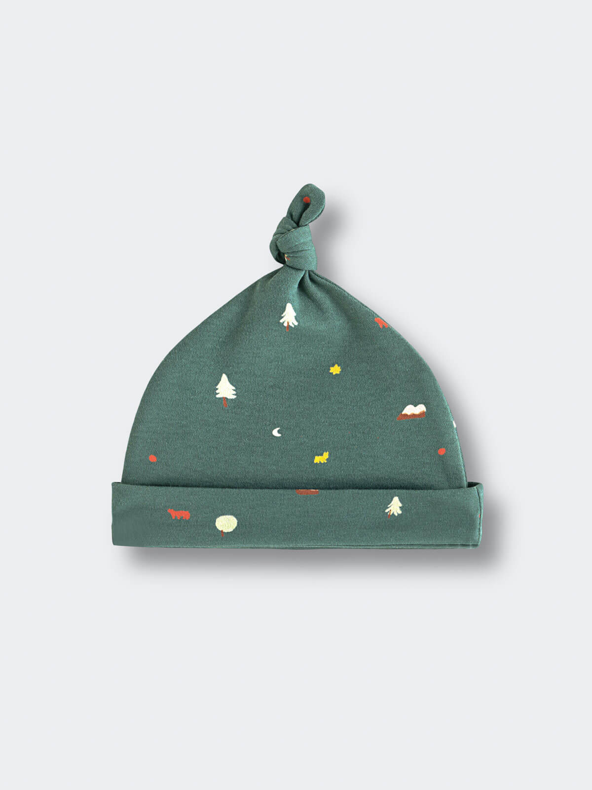 Green baby hat with knotted top featuring small trees and mountain motifs Knot Hat - Mountain View Balsam Baby boy