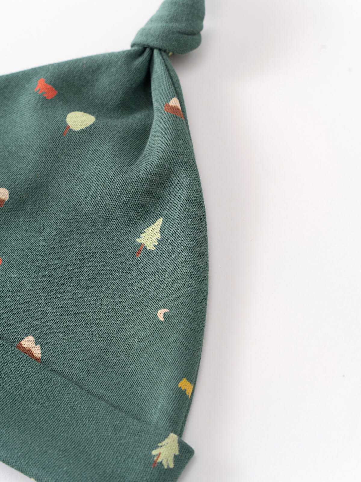 Green fabric hat with colorful tree embroidery pattern and knotted top Knot Hat - Mountain View Balsam Baby boy