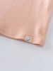 Close-up of peach fabric hem with small smiley face label tag Long Sleeve Jersey Dress - Mallow Girls