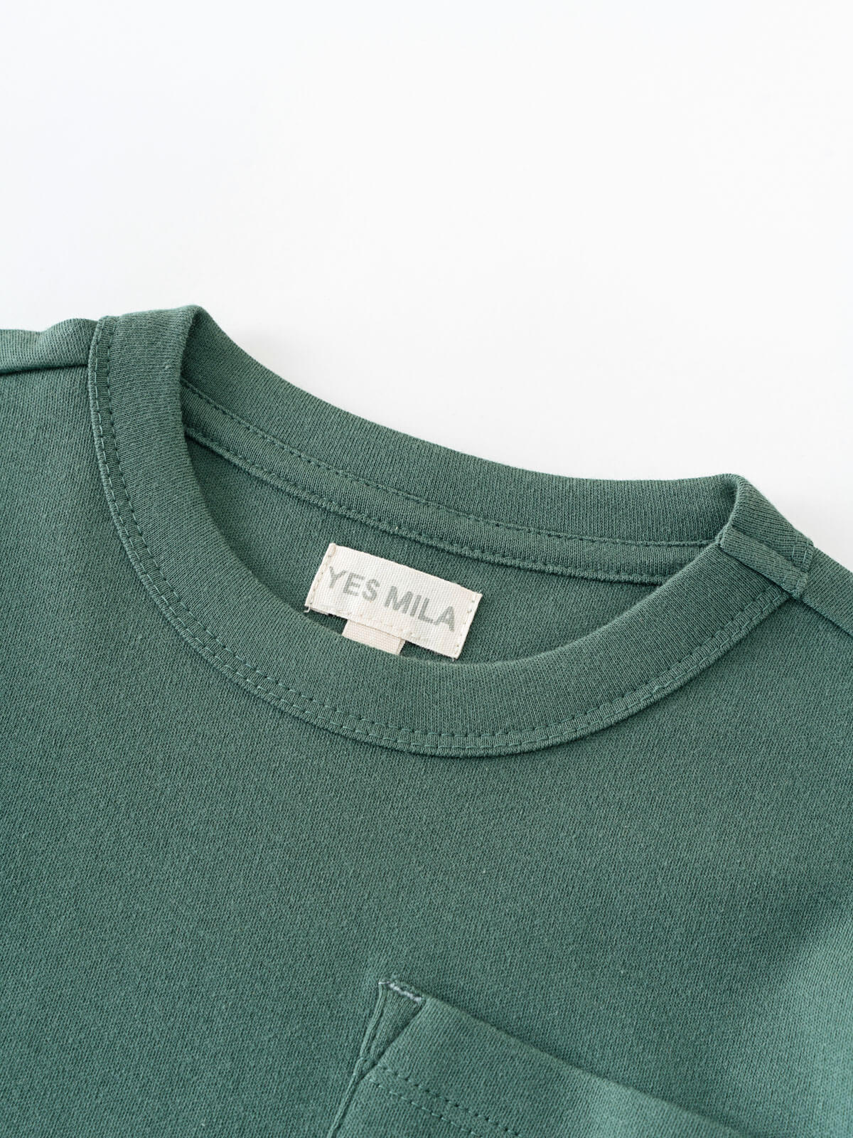 Close-up of a green long sleeve tee collar with white label Long Sleeve Tee - Balsam Boys