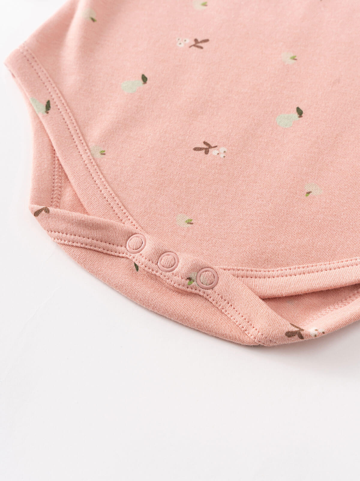 Close-up of pink baby bodysuit with bunny print and snap buttons Long Sleeve Bodysuit - Autumn Harvest Rosehip Baby girl