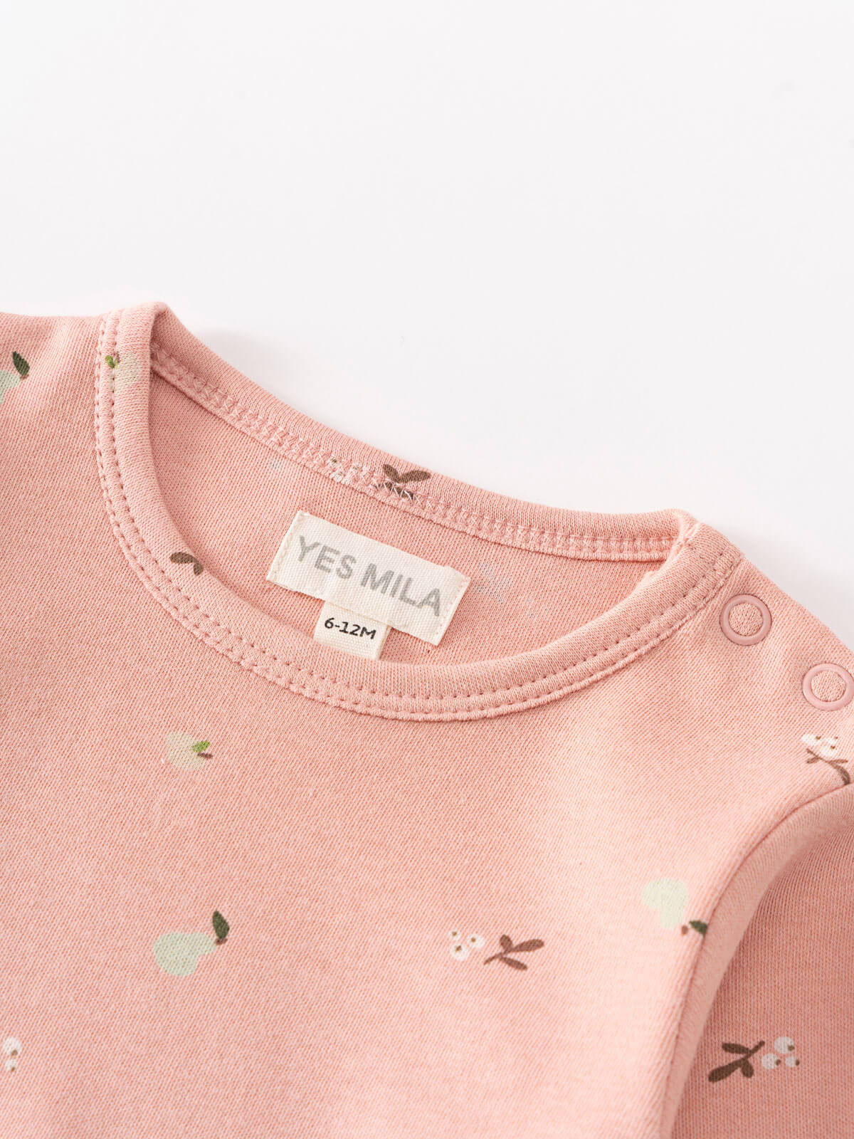 Close-up of pink baby bodysuit neckline showing label and floral print Long Sleeve Bodysuit - Autumn Harvest Rosehip Baby girl