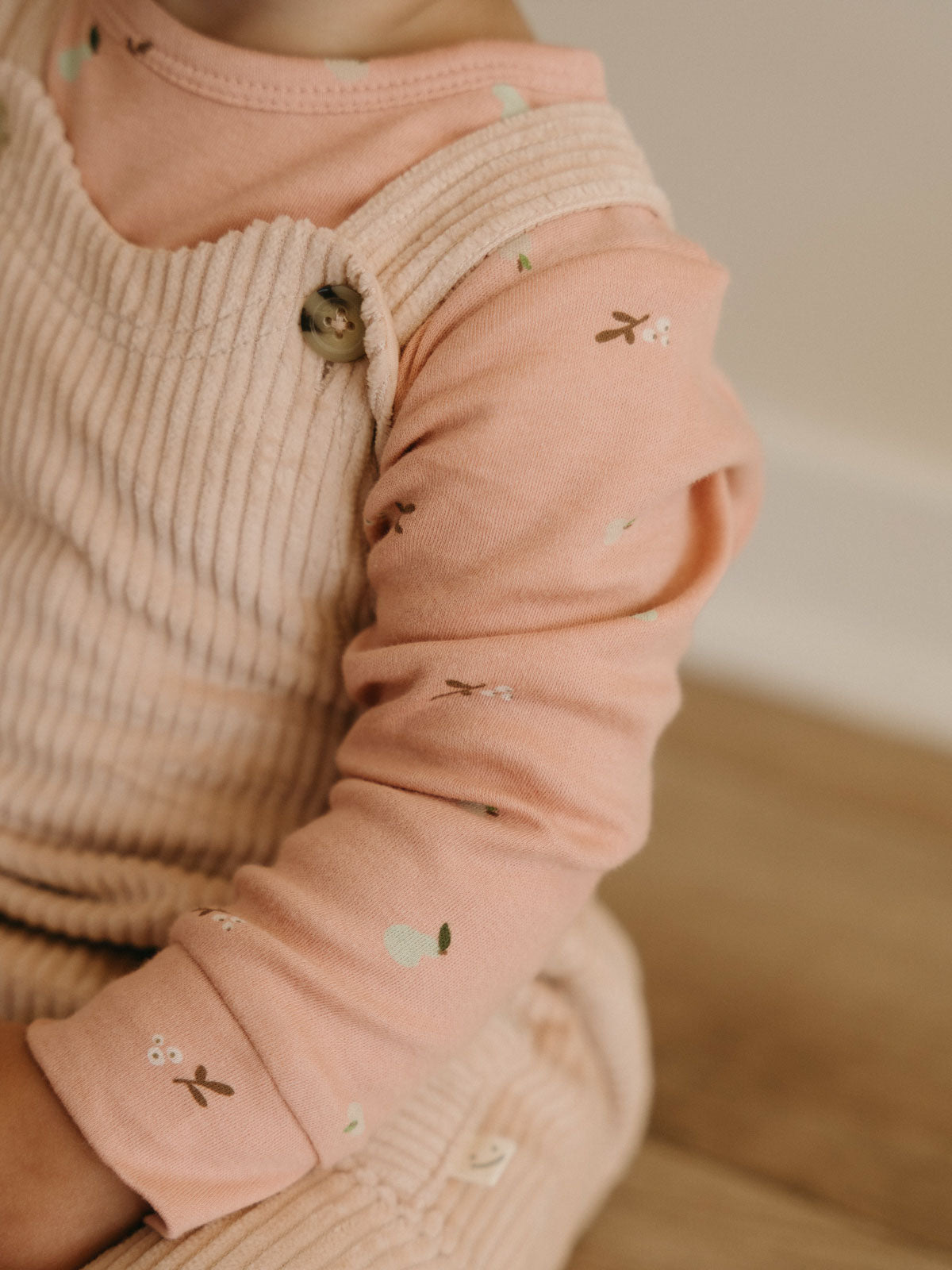 Baby wearing pink patterned long sleeve bodysuit with cream ribbed vest Long Sleeve Bodysuit - Autumn Harvest Rosehip Baby girl