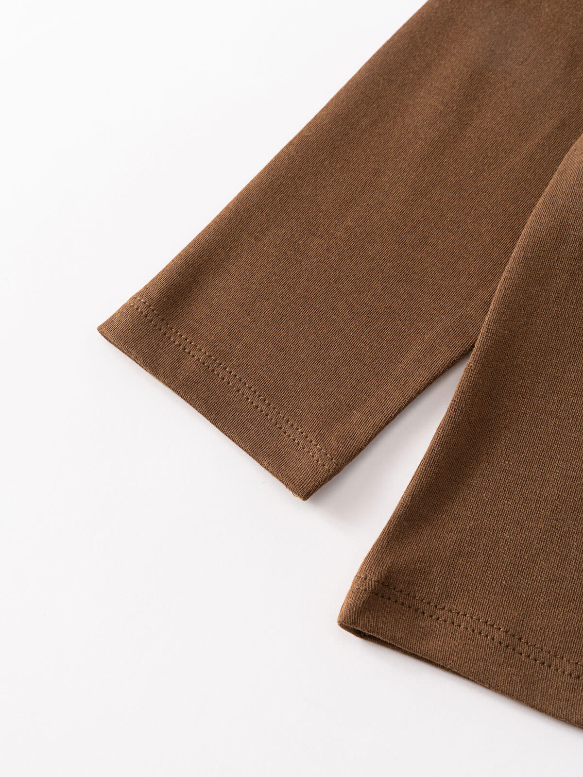 Close-up of brown ribbed fabric sleeve cuffs on white background Long Sleeve Tee - Spruce Boys
