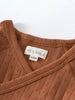 Close-up of a rust-colored knitted garment with white label showing size Pointelle Crossover Bodysuit - Russet Baby boy