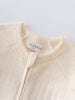 Close-up of a cream-colored sweater with 'YES MILA' label on a light gray background Pointelle Long Sleeve One Piece - Ecru Baby boy