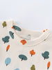 Close-up of cream-colored shirt collar with printed tree pattern in orange and teal Printed Short Sleeve Tee - Forest Adventure Ecru Boys
